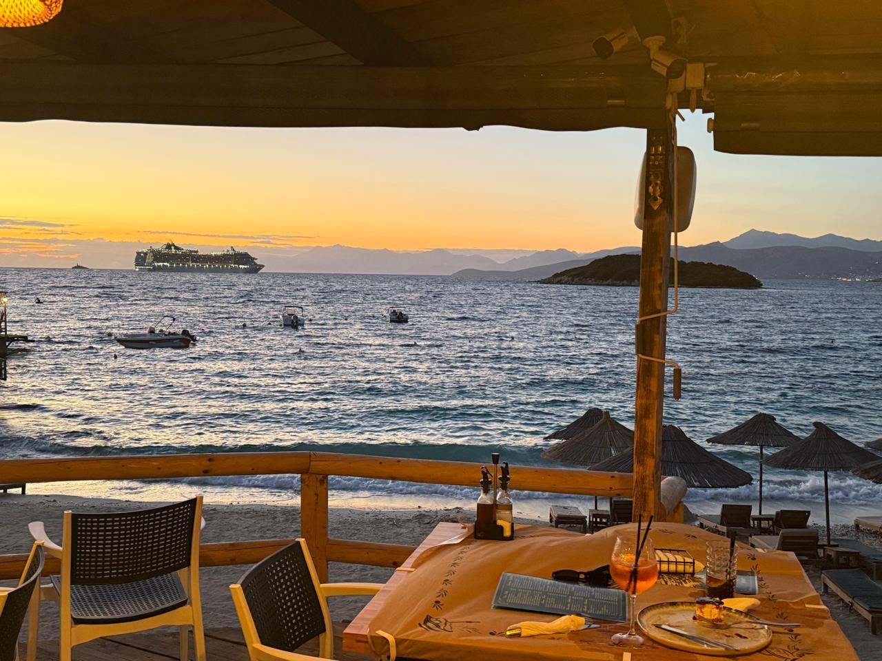 Bamboo-roofed dining deck at Summer Gate Ksamil with Ionian view